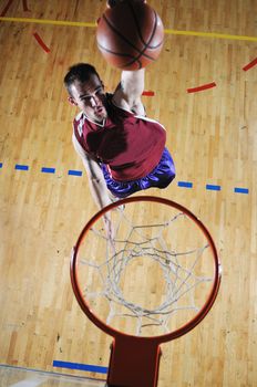 one healthy young  man play basketball game in school gym indoor