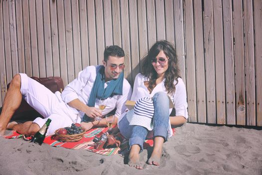 happy young couple enjoying  picnic on the beach and have good time on summer vacations