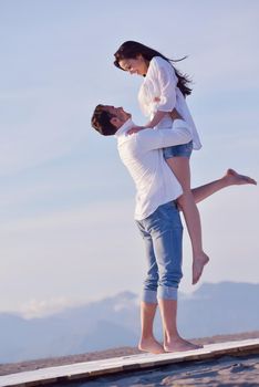 happy young romantic couple in love have fun on beautiful beach at beautiful summer day