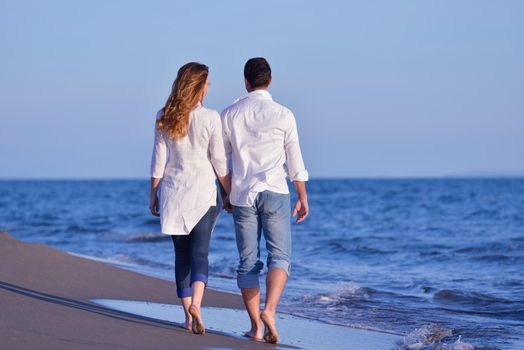 happy young romantic couple in love have fun on beautiful beach at beautiful summer day