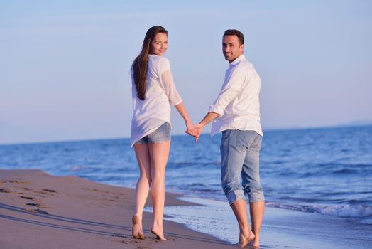 happy young romantic couple in love have fun on beautiful beach at beautiful summer day