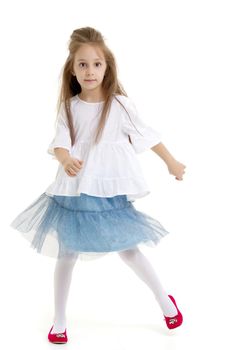 Beautiful little girl is having fun dancing in the studio on a white background. The concept of a school of dance, happy people. Isolated.