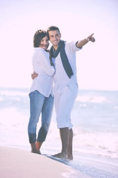 happy young couple in white clothing  have romantic recreation and   fun at beautiful beach on  vacations