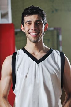 one basket ball game player standing in sport gym with ball