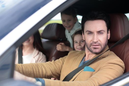 Family sitting in the car looking out windows.family weekend