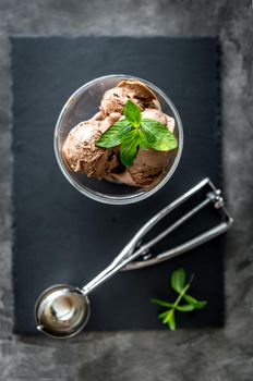 Delicious homemade ice cream with bananas and strawberries served with ice and mint leaves, topview