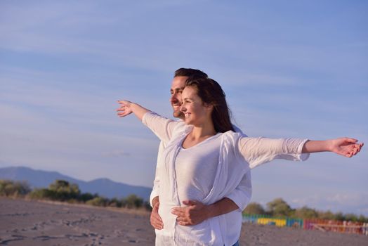 happy young romantic couple in love have fun on beautiful beach at beautiful summer day