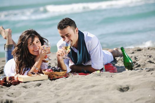 happy young couple enjoying  picnic on the beach and have good time on summer vacations