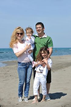 happy young family have fun and live healthy lifestyle on beach