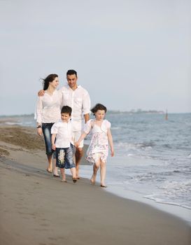 happy young family have fun and live healthy lifestyle on beach