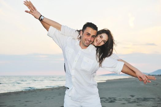 happy young couple have fun and romantic moments on beach at summer season and representing happynes and travel concept