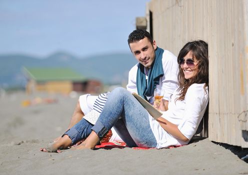 happy young couple enjoying  picnic on the beach and have good time on summer vacations