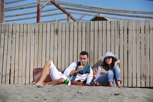 happy young couple enjoying  picnic on the beach and have good time on summer vacations