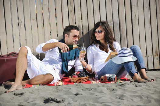 happy young couple enjoying  picnic on the beach and have good time on summer vacations