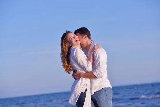 happy young romantic couple in love have fun on beautiful beach at beautiful summer day