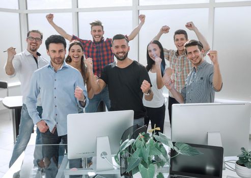 happy business team standing in modern office. Best team ever