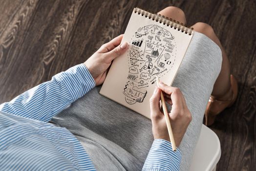 close-up, woman draws business notes in her notebook. Business Innovation Concept