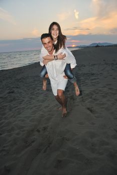 happy young couple have fun and romantic moments on beach at summer season and representing happynes and travel concept