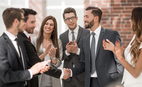 smiling business people shaking hands with each other.the concept of cooperation