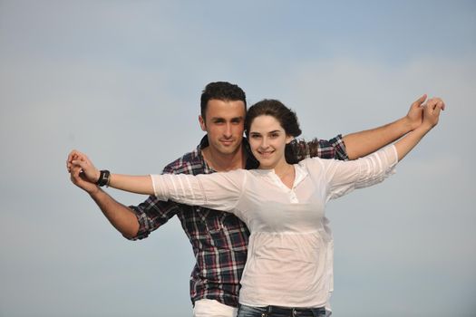 happy young couple have fun and romantic moments on beach at summer season and representing happynes and travel concept