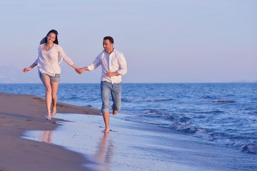 happy young romantic couple in love have fun on beautiful beach at beautiful summer day