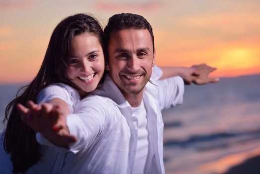 happy young romantic couple in love have fun on beautiful beach at beautiful summer day