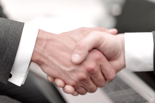 close up. handshake business partners.the concept of cooperation