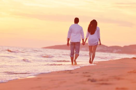 happy young romantic couple in love have fun on beautiful beach at beautiful summer day