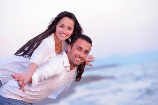 happy young romantic couple in love have fun on beautiful beach at beautiful summer day