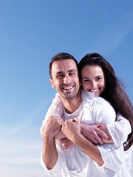 happy young romantic couple in love have fun on beautiful beach at beautiful summer day