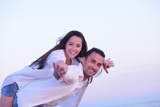 happy young romantic couple in love have fun on beautiful beach at beautiful summer day