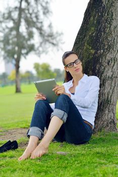 Beautiful young student  woman study with tablet in park