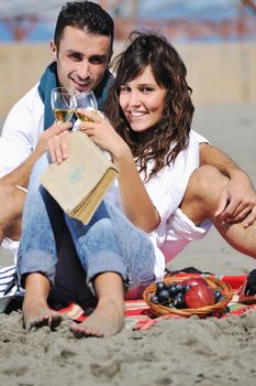 happy young couple enjoying  picnic on the beach and have good time on summer vacations