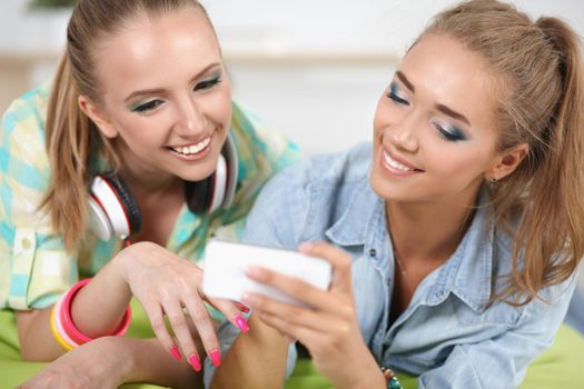 Two girls taking pictures on the phone