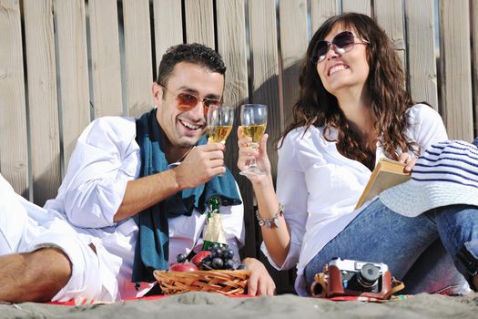 happy young couple enjoying  picnic on the beach and have good time on summer vacations