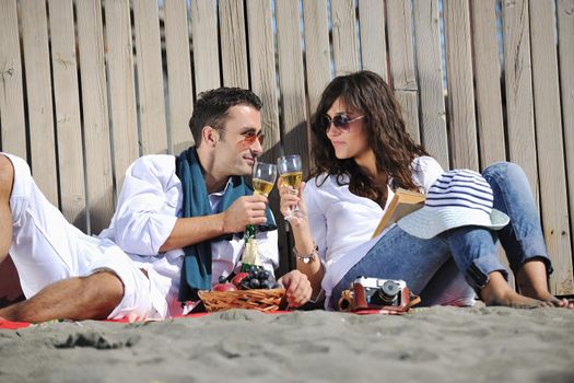 happy young couple enjoying  picnic on the beach and have good time on summer vacations