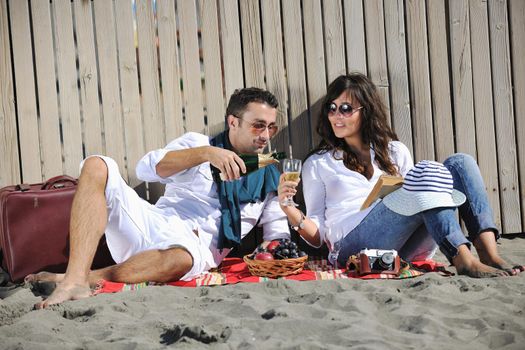 happy young couple enjoying  picnic on the beach and have good time on summer vacations