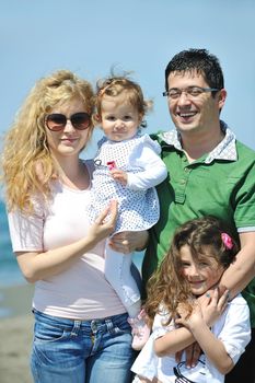 happy young family have fun and live healthy lifestyle on beach