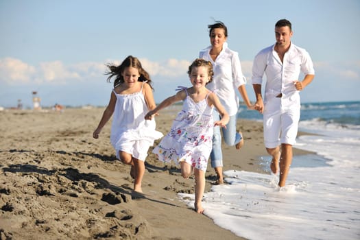 happy young family in white clothing have fun at vacations on beautiful beach 