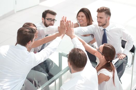 successful business team giving each other a high five.the concept of unanimity