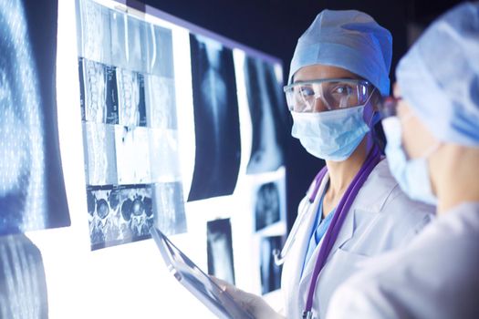 Two female women medical doctors looking at x-rays in a hospital