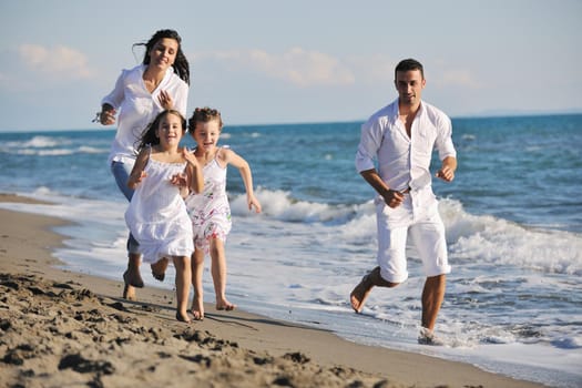 happy young family in white clothing have fun at vacations on beautiful beach 