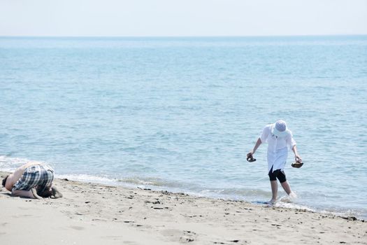 happy young couple have fun and romantic moments on beach at summer season and representing happynes and travel concept