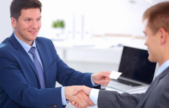 Business people shaking hands, finishing up a meeting, in office