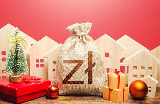 Polish zloty money bag and houses in a New Year's setting. New Year or Xmas winter holiday. Increase in investment attractiveness. Mortgage loans. Bank deposit. Promotions, offers.