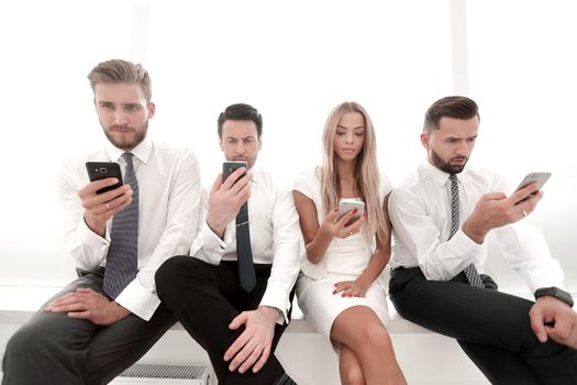 close up.Business people using smartphones sitting in a row.people and technology