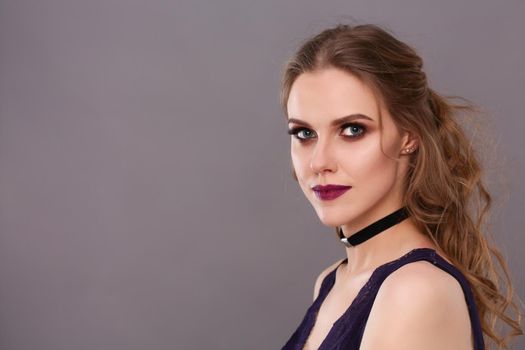 Portrait of beautiful young woman face. Isolated on gray background.