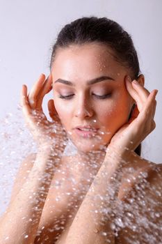 Young beautyful woman under shower in bathroom