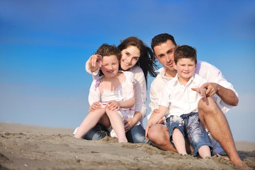 happy young family have fun and live healthy lifestyle on beach