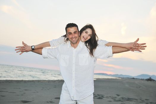 happy young couple have fun and romantic moments on beach at summer season and representing happynes and travel concept